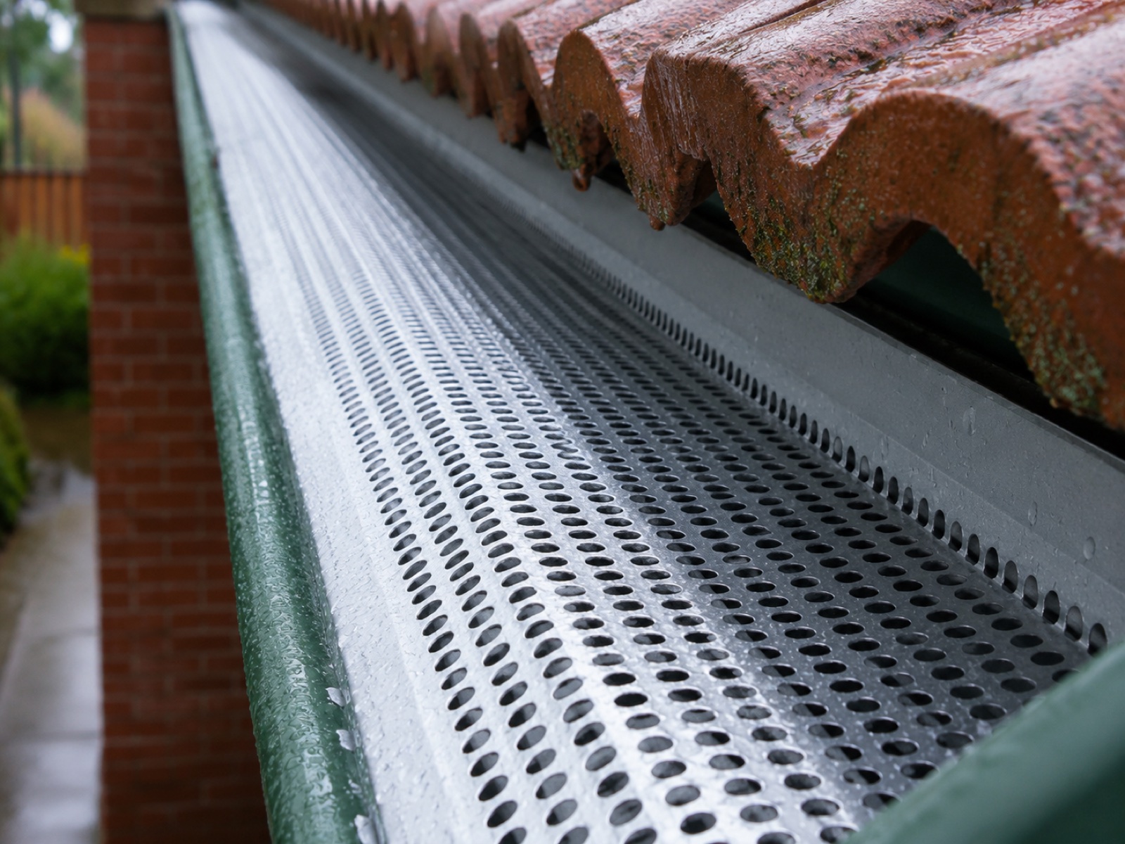 Gutter guard installed along a roofline by Breeze Plumbing